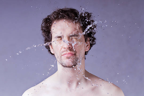 istock Washing up. Handsome man with splashing water on his face. 511457272