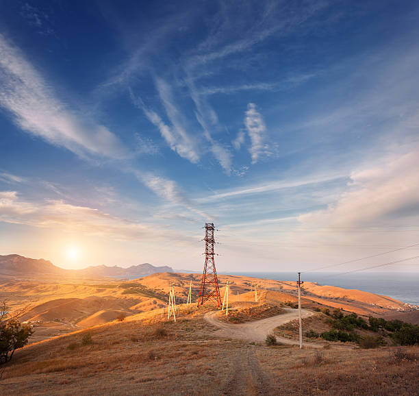 istock High voltage tower in mountains at sunset. Electricity pylon system 511459028