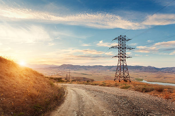 torre de alta tensão nas montanhas ao pôr do sol. torre de alta-tensão do sistema - blue cloudscape contemporary electricity imagens e fotografias de stock