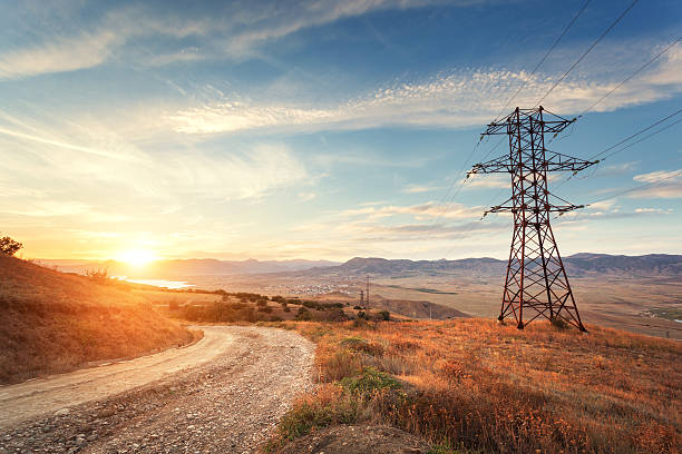 istock High voltage tower in mountains at sunset. Electricity pylon system 511459228