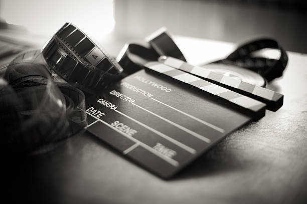 Movie clapper board and filmstrip selective focus