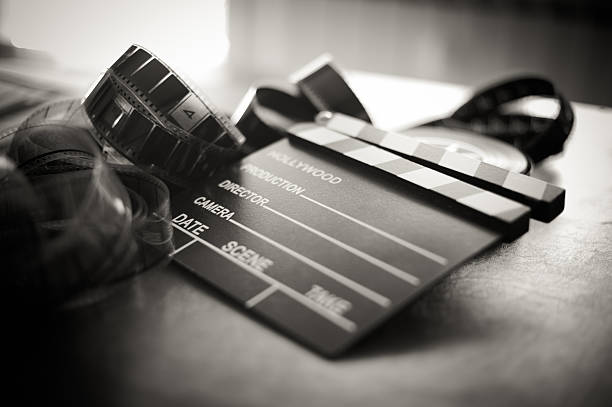 Movie clapper board and filmstrip selective focus Movie clapper board and filmstrip selective focus and vintage black and white audition photos stock pictures, royalty-free photos & images