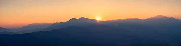 istock Panorama of hills and mountains at golden hour with sunset 511459904