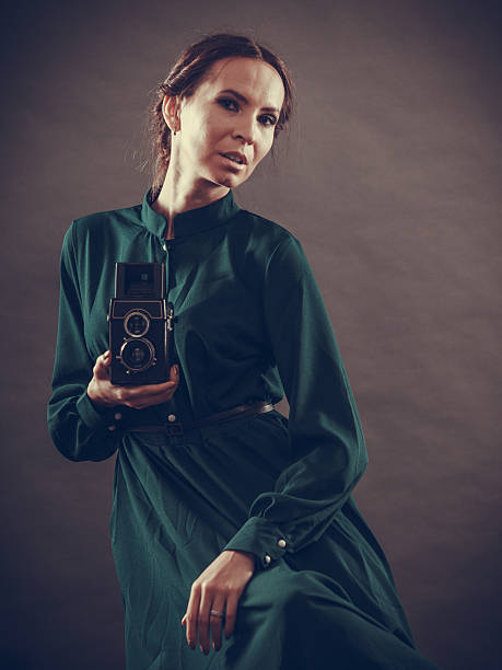 istock Woman retro style with old camera 511460290