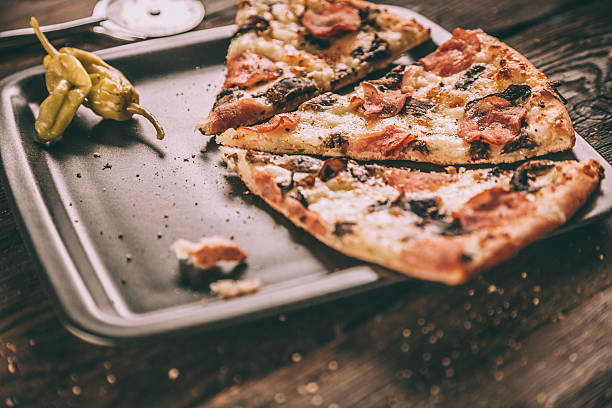 istock Homemade Pizza Slices with ham and mushrooms 511461456