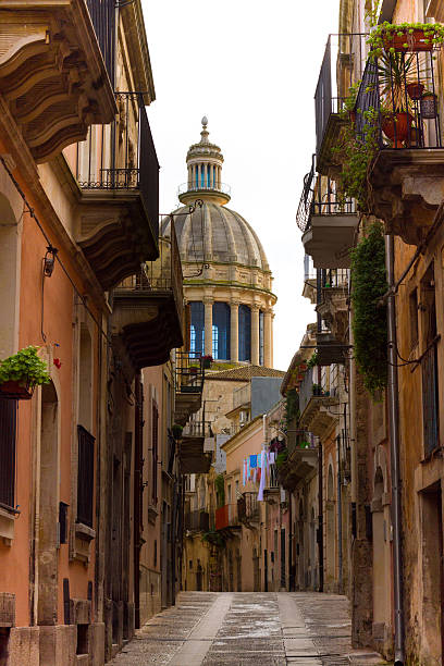 istock Ragusa Ibla, Sicily: Narrow Alley with St George Cathedral Dome 511463388