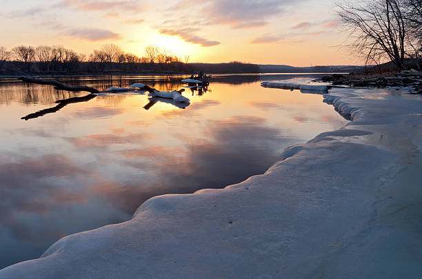 mississippi river in south saint paul minnesota at sunrise in winter along icy banks