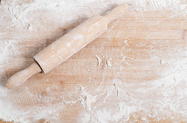 istock Rolling pin on a wooden tray covered with flour 511464030