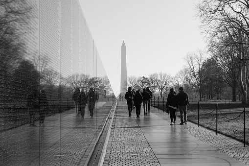 Washington DC, United States - December 6, 2015: People visit the Vietnam Veterans Memorial on a sunny late autumn day.