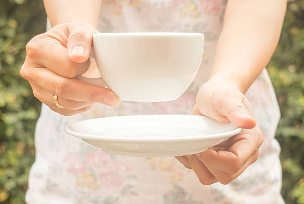 istock Hand on cup of coffee with vintage filter 511466782