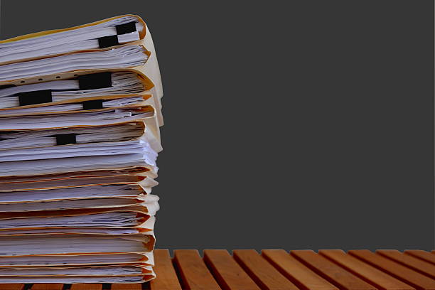 istock Stack of Legal Folders on Dark Grey Background 511467956