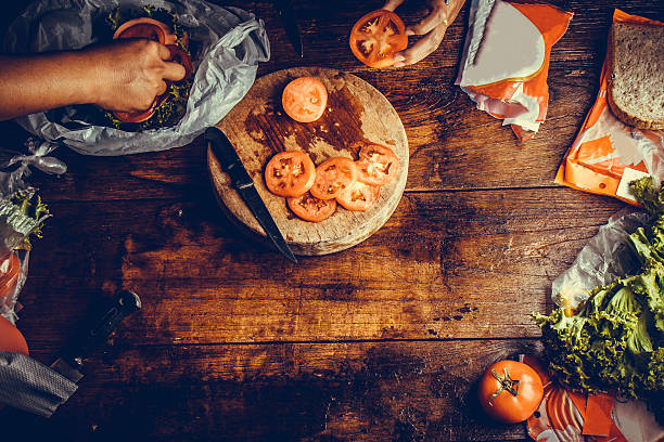 People prepare meal on wooden table stock photo