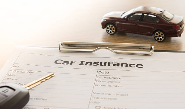 car insurances car insurance application form with car model and key remote on desk. car insurance photos stock pictures, royalty-free photos & images