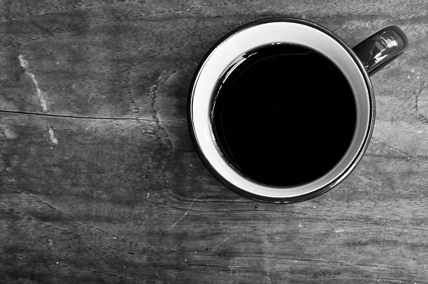 istock Cup of black coffee  on wooden background.Black and white 511472541