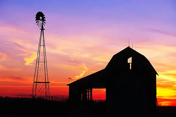 Photo of Beautiful windmill and barn at sunset
