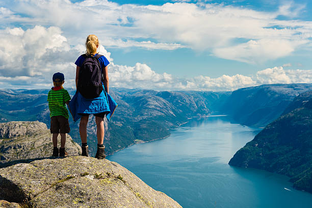 Lysefjorden mother and child looking down to Lysefjorden in Norway. Near famous Preikestolen , Pulpit Rock. ryfylke stock pictures, royalty-free photos & images