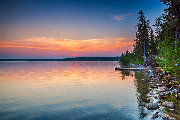 Colourful Sunrise, Clear Lake Manitoba Gorgeous sunrise over Clear Lake in Riding Mountain National Park, Manitoba Canada manitoba photos stock pictures, royalty-free photos & images