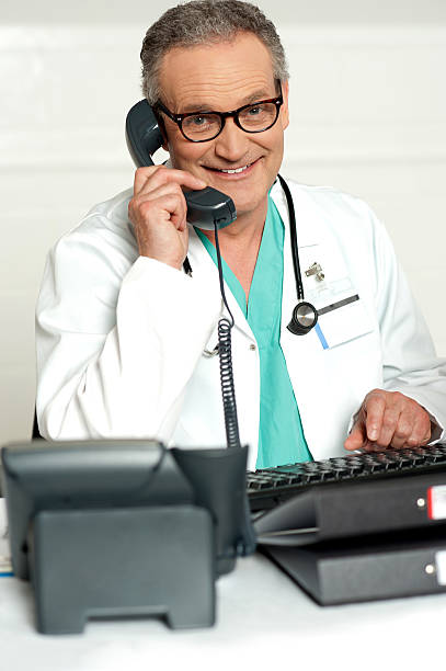 istock Happy aged medical expert taking on phone 511474051