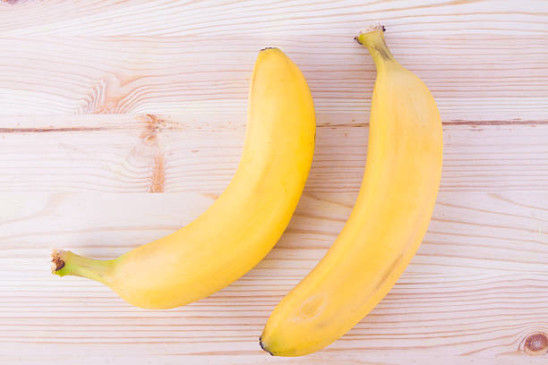 istock Fresh bananas on wooden background 511474204