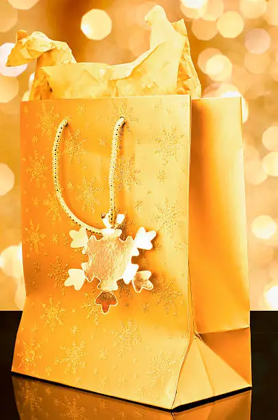 Golden gift bag on golden background
