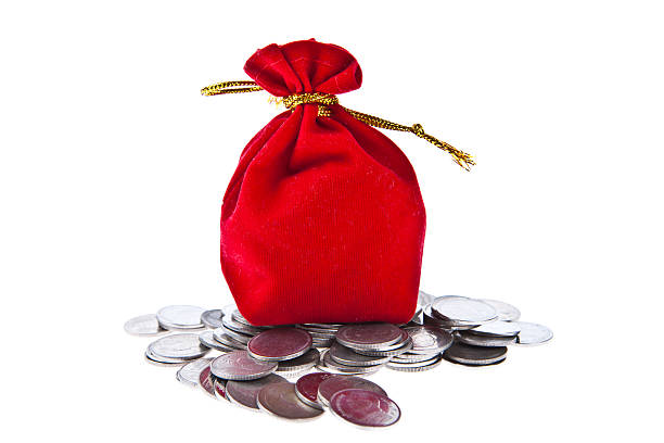 istock Red velvet pouch with coins isolated on white background 511474864
