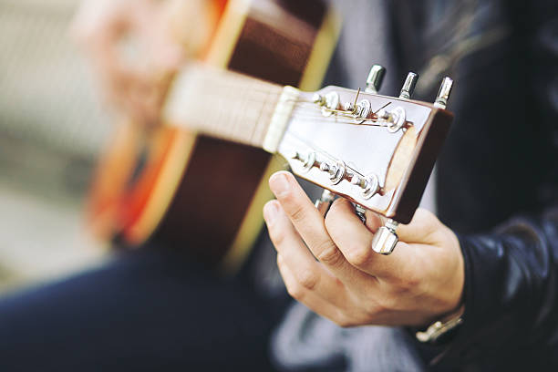 istock Young attractive street artist with his guitar 511474946