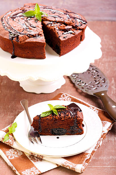 Prune and chocolate torte Prune and chocolate torte, selective focus sunken cake stock pictures, royalty-free photos & images