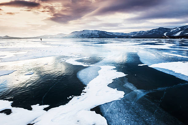 istock Frozen lake and mountains at sunset. 511475970