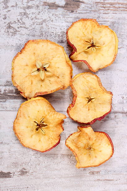istock Slices of dried apple on old rustic wooden background 511476014