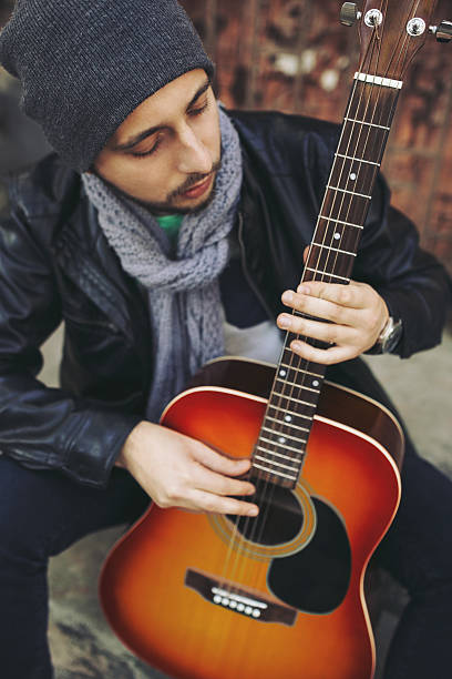 istock Young musician with guitar in city 511476384