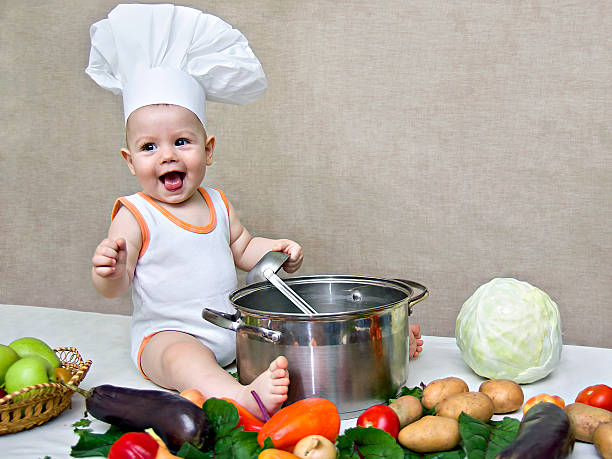 istock little baby in a chef's hat and ladle in hand 511476587