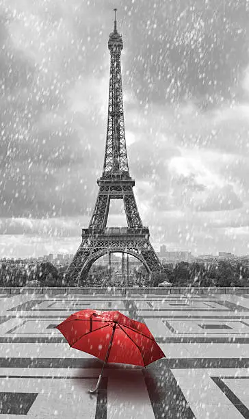 Photo of Eiffel tower in rain. Black white photo with red element