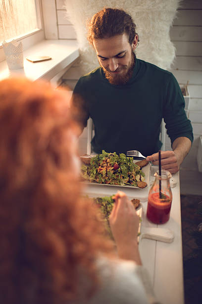 istock Smiling man enjoying in a lunch with his girlfriend. 511477584