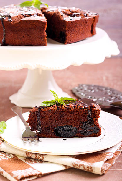 Prune and chocolate torte Prune and chocolate torte, selective focus sunken cake stock pictures, royalty-free photos & images