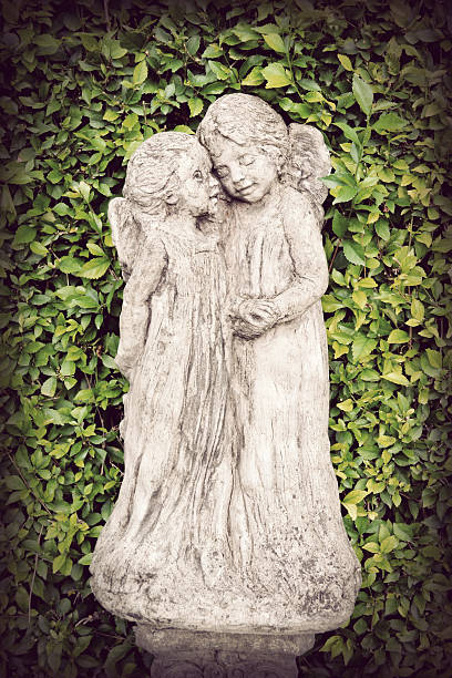 istock two angle statues on green background, retro vintage film style 511478645