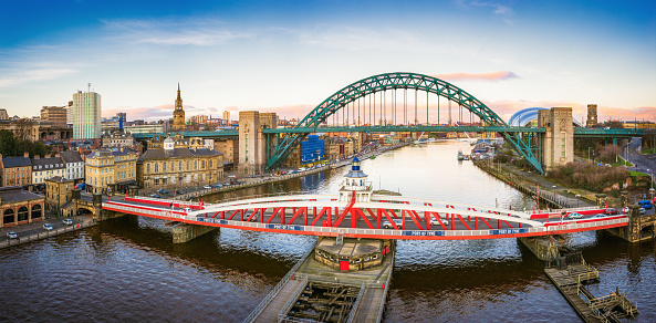 Taken at sunset, a view looking down the River Tyne in central Newcastle.  The Swing Bridge, Tyne Bridge and Gateshead Millennium Bridge over the river are visible.