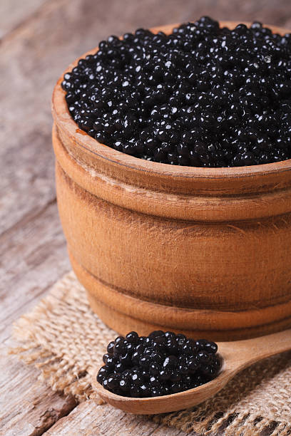 istock black sturgeon caviar in a wooden closeup. Vertical 511479215