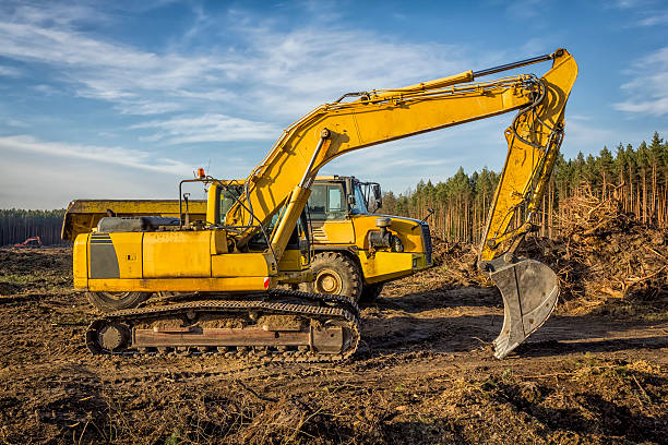 istock Excavator and dump truck on a new road construction 511479356