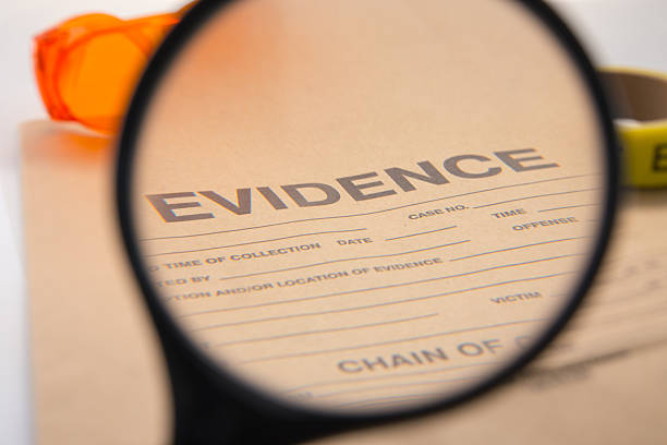 magnifying glass focus on evidence bag stock photo