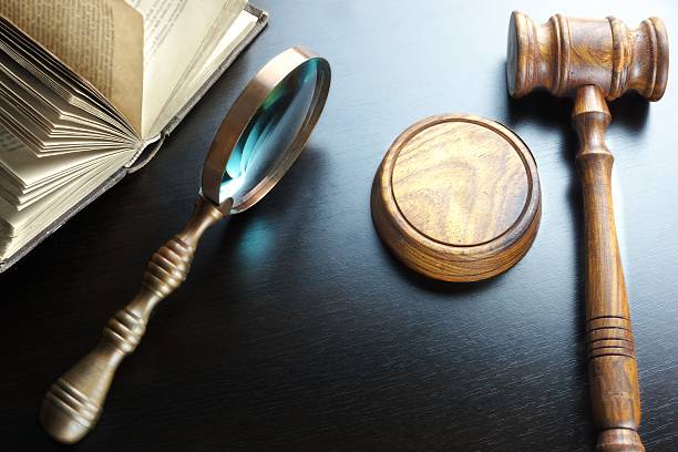 istock Judges Gavel, Magnifier And Old Book On The Black Table 511482408