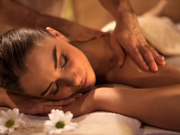 istock Smiling woman relaxing during back massage at spa. 511482600