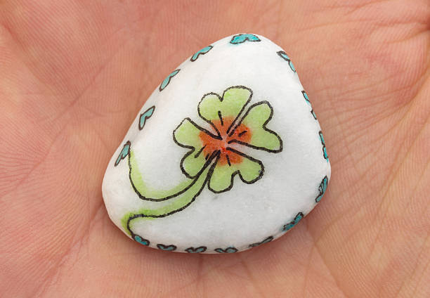 Stone with drawing of a clover four and small hearts