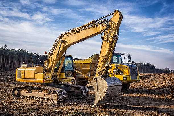 istock Excavator and dump truck on a new road construction 511483274