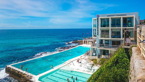 Sydney, Australia - November 9, 2015: Bondi Icebergs, a popular bar in Bondi Beach, and people swimming in the pool in Sydney, Australia