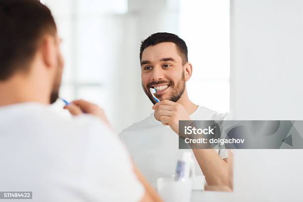 Man With Toothbrush Cleaning Teeth At Bathroom Stock Photo - Download Image Now - Brushing, Human Teeth, Brushing Teeth