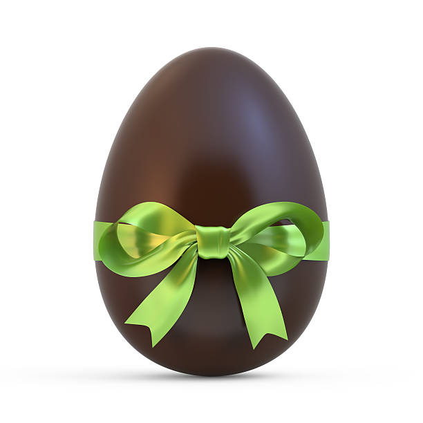 uovo di pasqua al cioccolato con nastro verde su sfondo bianco - easter egg easter isolated three dimensional shape foto e immagini stock