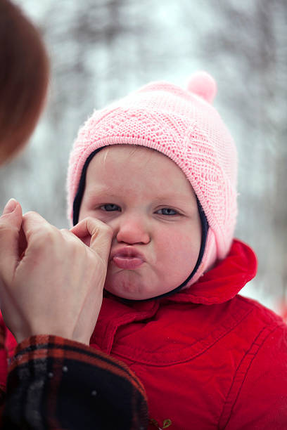 Mother Wiping Tears from Child Face Closeup shot of crying baby girl, mother is wiping tears from her face. wiping tears stock pictures, royalty-free photos & images