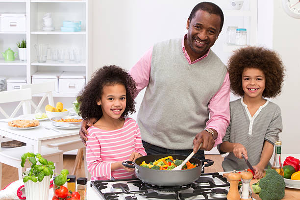 istock Grandfather and Children Cooking a Meal 511508471