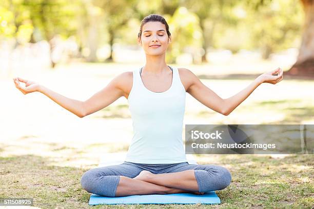 Relaxed Woman Practicing Yoga Chant At Park Stock Photo - Download Image Now - 20-24 Years, 20-29 Years, Adult