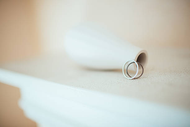 istock Wedding rings on the pure white table 511513536